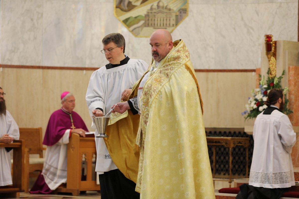 Father Jerry Pilus blesses the congregation at the start of the centennial Mass