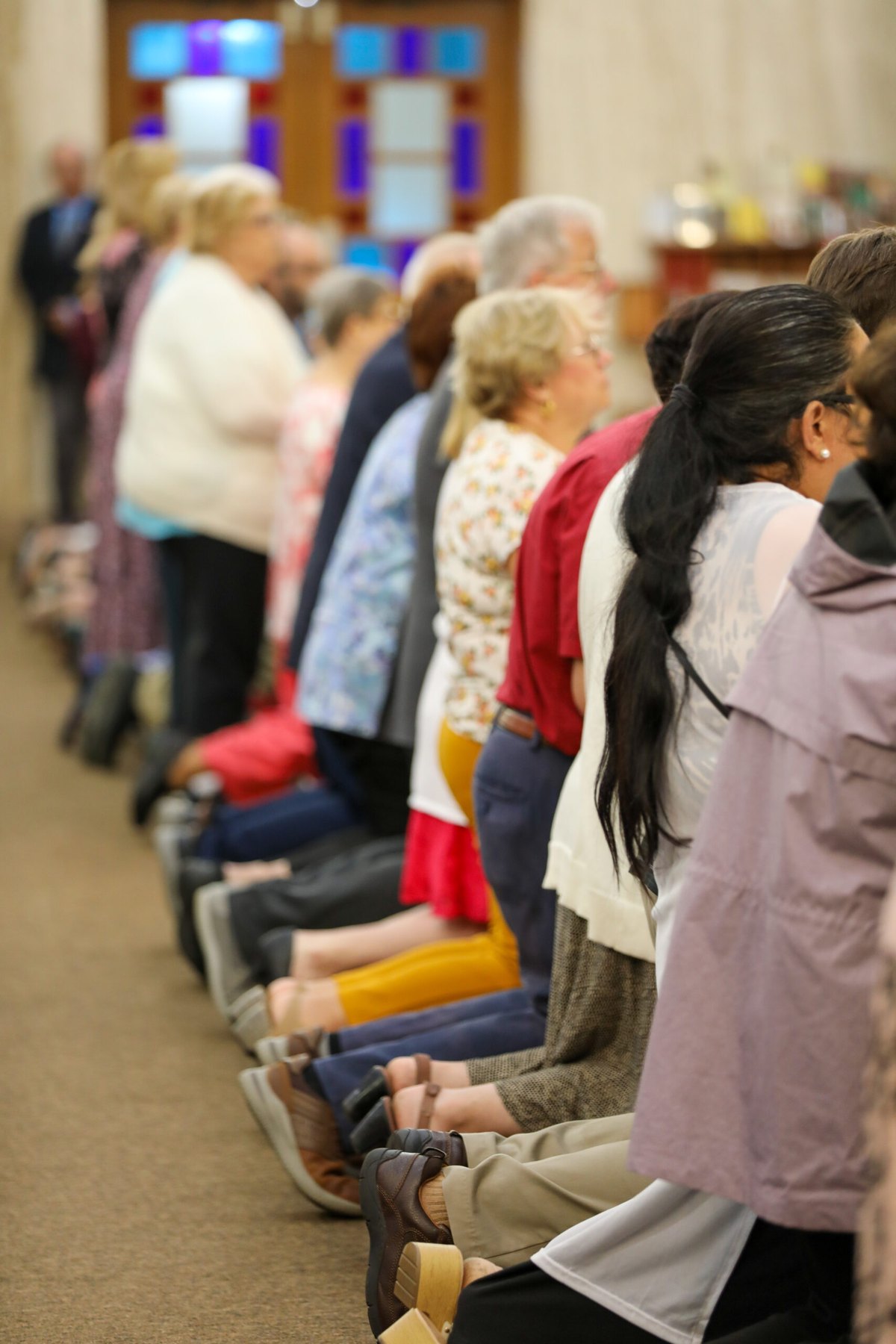 Parishioners kneel in prayer