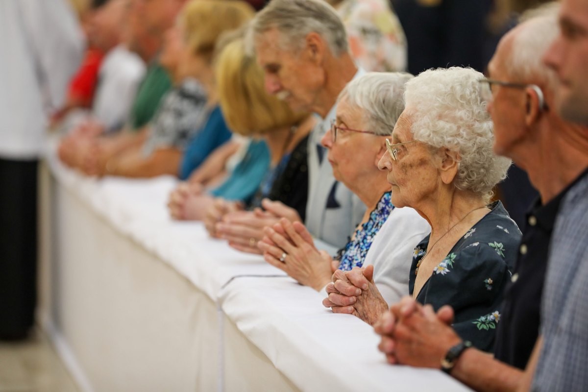 Parishioners kneel at the altar rail