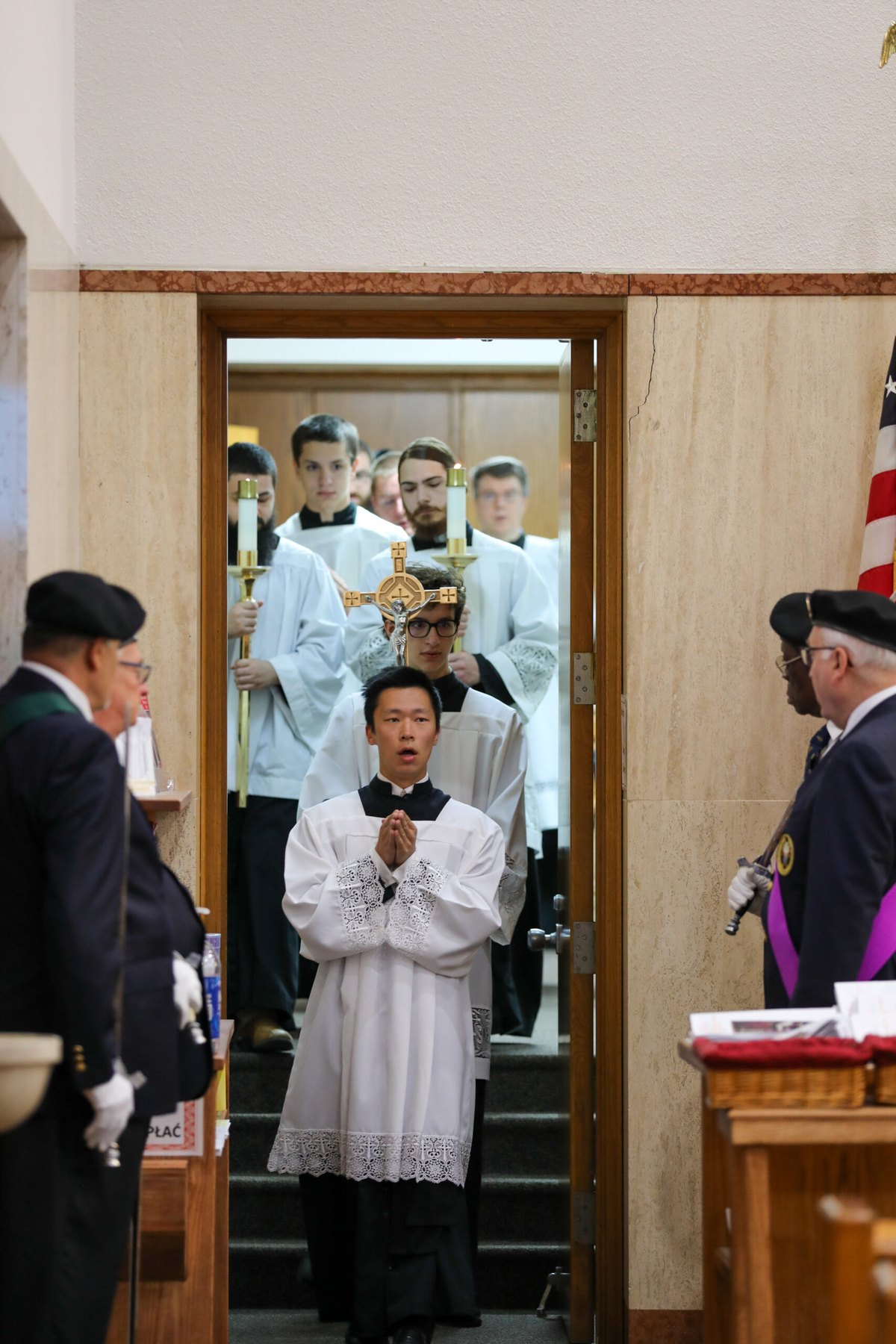Altar servers wait to process in