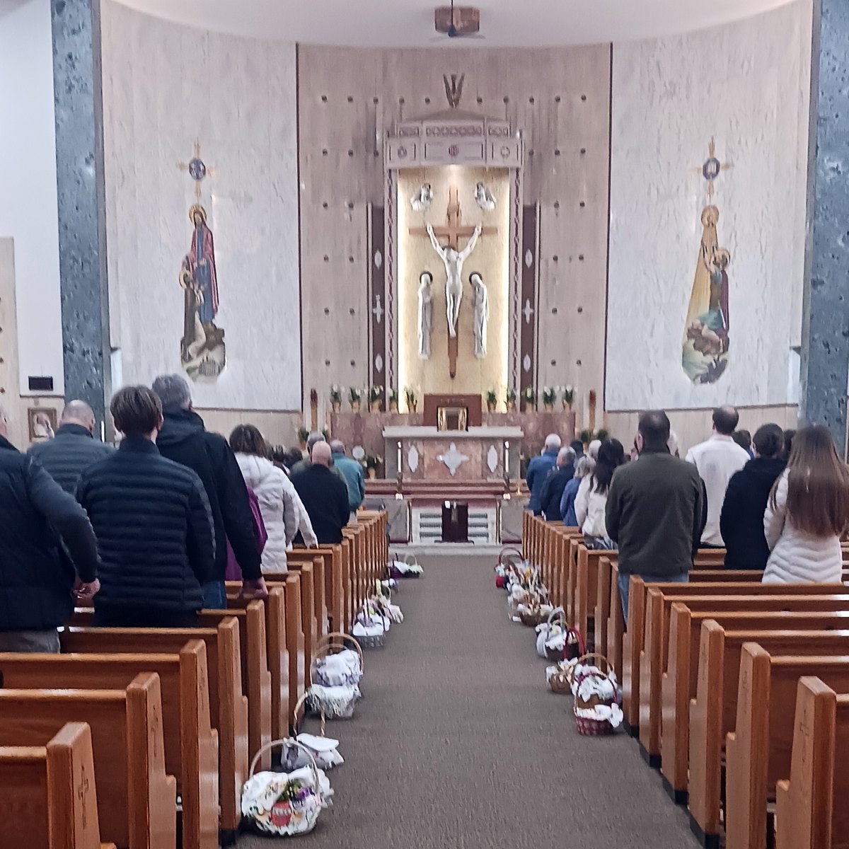 Easter baskets line the center aisle for the Holy Saturday blessing