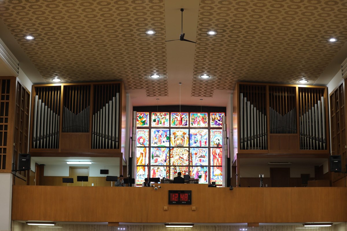 The choir loft, organ pipes and window