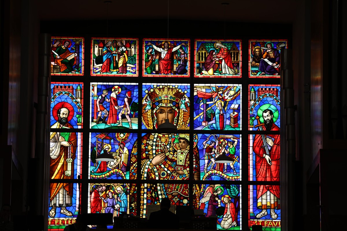 Stained glass window of Our Lady of Częstochowa flanked by St. Peter and St. Paul